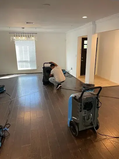 Technician setting a dehumidifier during a La Mesa water damage dry-out