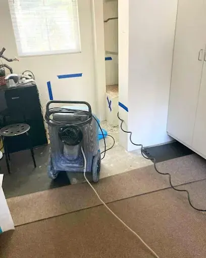 Dehumidifier running in a room during a water damage dry-out