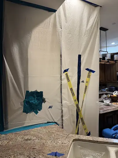 Plastic containment wall set up during a water damage job