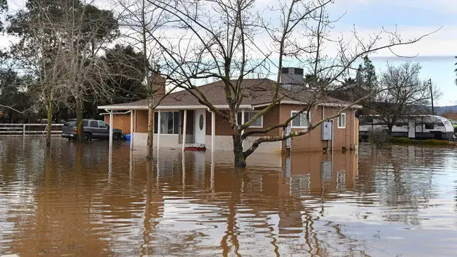Ranch home surrounded by storm flood water in La Mesa