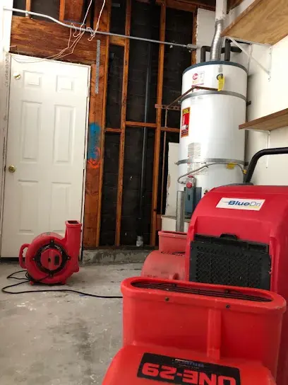 Water heater in an opened closet with a dehumidifier and air mover drying the space